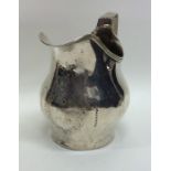 A Georgian silver helmet shaped cream jug with sha