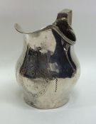 A Georgian silver helmet shaped cream jug with sha