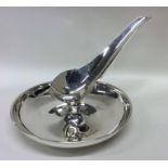 A heavy circular silver inkstand of stylised form.