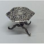 A small silver table toy in the form of a table em