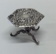 A small silver table toy in the form of a table em