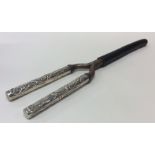 A pair of silver handled curling tongs. Approx. 14