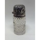 A small silver mounted scent bottle with hobnail c