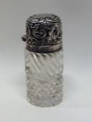 A small silver mounted scent bottle with hobnail c
