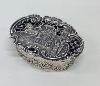 A good quality oval silver pierced box chased with