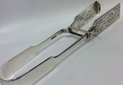 A pair of large fiddle pattern silver asparagus to