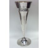 A tall tapering silver shaped spill vase with gilt