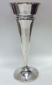 A tall tapering silver shaped spill vase with gilt
