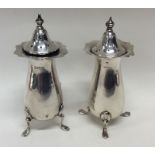 A pair of Edwardian silver peppers with lift-off c