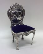 A large silver pin cushion in the form of a chair