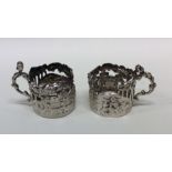 A pair of unusual pierced silver shot glass holder