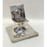 An unusual silver inkwell / stamp holder on square