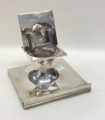 An unusual silver inkwell / stamp holder on square