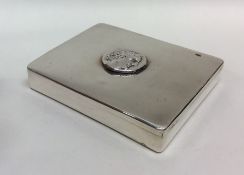 A silver plated hinged top box with central plaque
