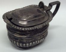 A heavy Edwardian silver mustard with hinged lid.