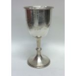 An oversized silver drinking cup decorated with fl