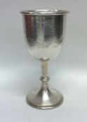 An oversized silver drinking cup decorated with fl
