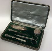 A cased silver dressing table set. Birmingham. Est