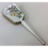 An attractive silver and enamelled brush decorated