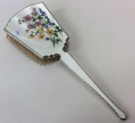 An attractive silver and enamelled brush decorated