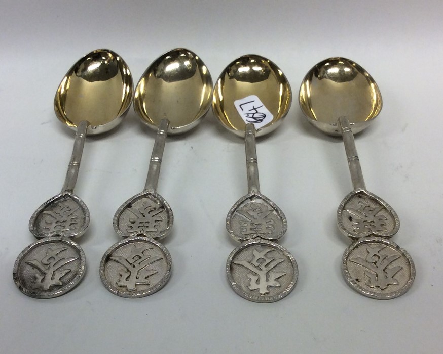 A heavy set of four Chinese silver teaspoons with