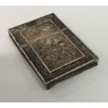 A silver filigree card case decorated with flowers