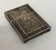 A silver filigree card case decorated with flowers