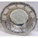 A large circular silver fruit bowl attractively de