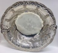 A large circular silver fruit bowl attractively de
