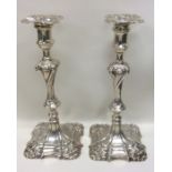 A pair of large cast silver candlesticks of swirl