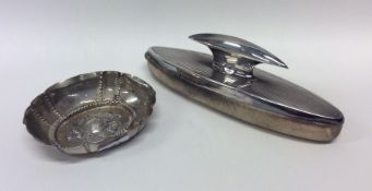 An oval silver Continental dish decorated with fru