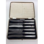 A cased set of six tapering silver handled knives.