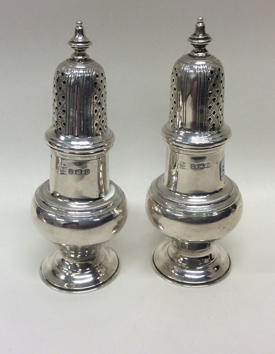 A pair of good quality silver sugar casters of Geo