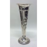 An engraved silver spill vase decorated with flowe