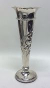 An engraved silver spill vase decorated with flowe