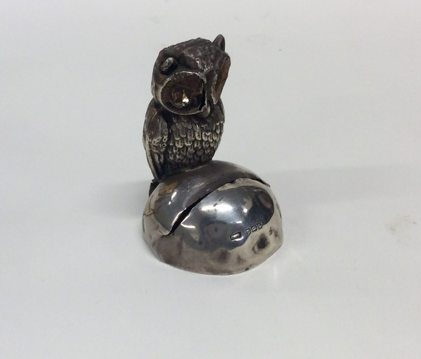 A novelty silver menu holder in the form of an owl