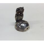 A novelty silver menu holder in the form of an owl