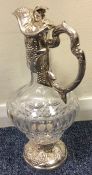 A good quality silver claret jug profusely decorat