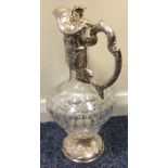 A good quality silver claret jug profusely decorat