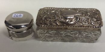 A circular silver and glass pill box together with