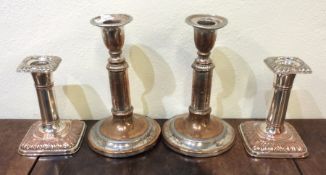 Two pairs of silver plated candlesticks. Est. £20