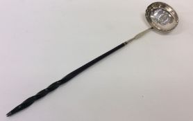 A Georgian silver whalebone toddy ladle with coin