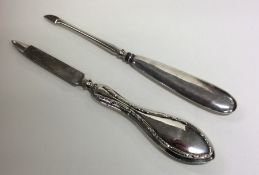 Two silver handled manicure implements. Approx. 28