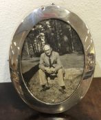 An oval silver picture frame. London. By WC. Appro
