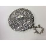 A good embossed silver mirror decorated with cheru