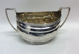 A Georgian silver cream jug with reeded border. Lo