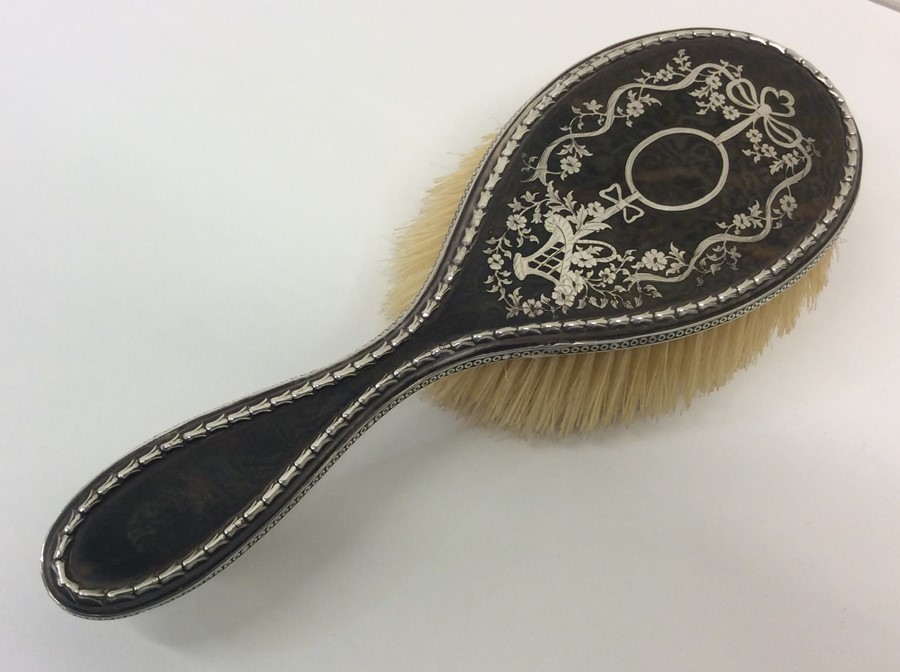 A good tortoiseshell and silver mounted hairbrush