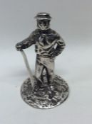 A heavy silver figure of a man in standing positio