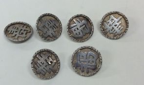 A set of six Chinese silver buttons with chased bo