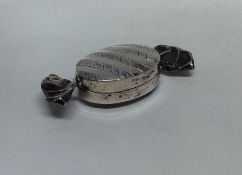 An unusual miniature silver pill box in the form o